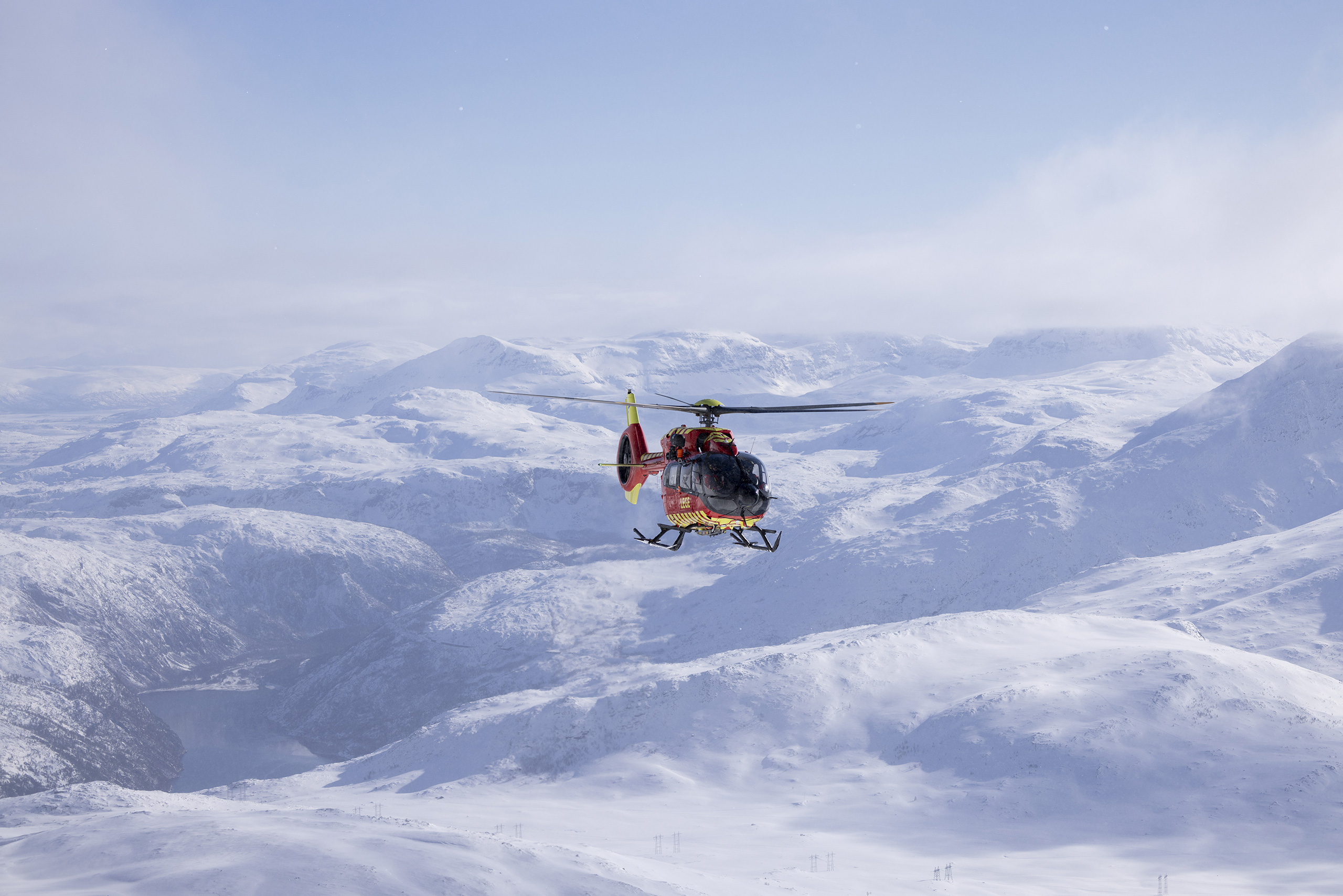 Development-helicopter flying over snowy mountains